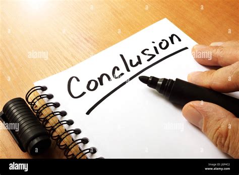 Hand is writing Conclusion on a note Stock Photo - Alamy 