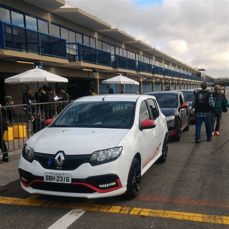 Several Cars Parked In Front Of An Airport With People Standing Around