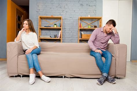 Premium Photo Man And Woman Sitting Separate On Couch After Quarrel