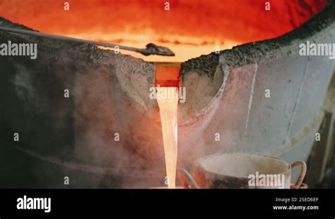 Hot Liquid Metal Stream Is Pouring From Induction Foundry Furnace Yellow Molten Stock Video