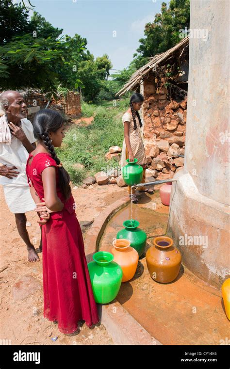 Rural Indian Village Girls Collecting Water From A Communal Water Tank Andhra Pradesh India