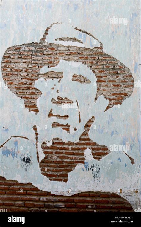 Artwork face on a brick wall Stock Photo - Alamy