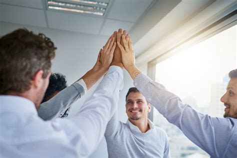 Striving Towards Team Excellence A Group Of Businesspeople High Fiving