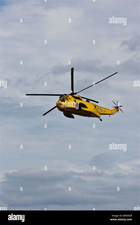 A Yellow Raf Rescue Sea King Helicopter Hovers Over Staithes North