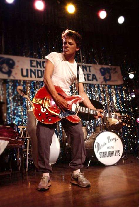 Michael J. Fox as Marty McFly with a cigarette in his mouth rehearsing ...