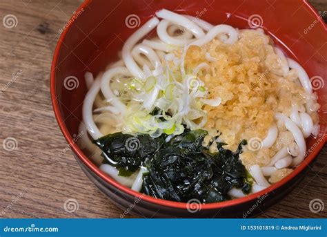 Udon in Broth with Wakame Seaweed, Tenkasu, Spring Onions, Fish Broth Stock Image - Image of ...