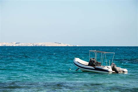 RIB Boat Floating on Tranquil Azure Sea WatersFree Stock Photo