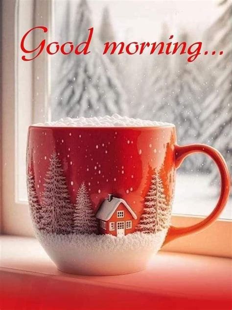 A Red Coffee Cup Sitting On Top Of A Window Sill Next To A Snow Covered