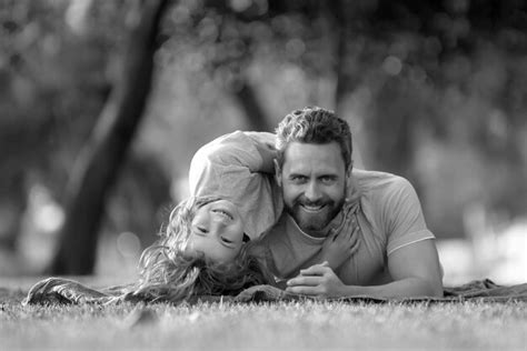 premium photo father  son laying  grass  nature park people