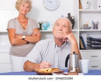 Senior Man Sitting Home Table Offended Stock Photo