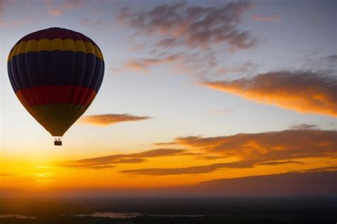 Premium AI Image Hot Air Balloon In The Sky With Beautiful Clouds At Sunset Background