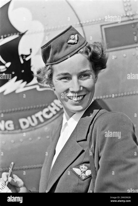 A Klm Flight Attendant Poses In Front Of An Aircraft With The Flying