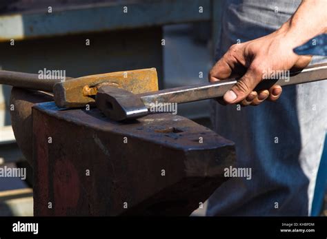 Blacksmith Performs The Forging Of Hot Glowing Metal On The Anvil Close Up Stock Photo Alamy