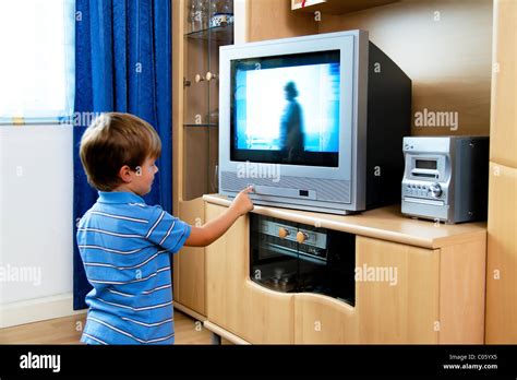 Little kid watching TV with TV Stock Photo - Alamy