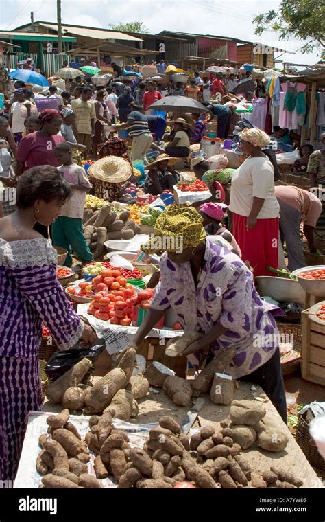 Traditional West African open air food market with market traders ...