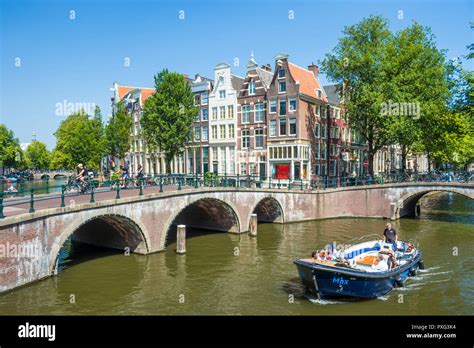 Amsterdam Canal Boat Going Under The Bridges Of Leidsegracht Canal At