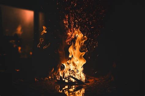 Premium Ai Image A Fire Burns In A Dark Room With The Word Fire On