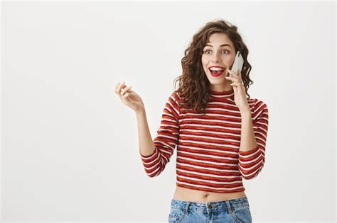 Free Photo Surprised Excited Woman Talking On Mobile Phone Smiling