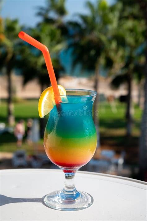 Colourful Cold Rainbow Paradise Cocktail Drink Served In Glass At Pool