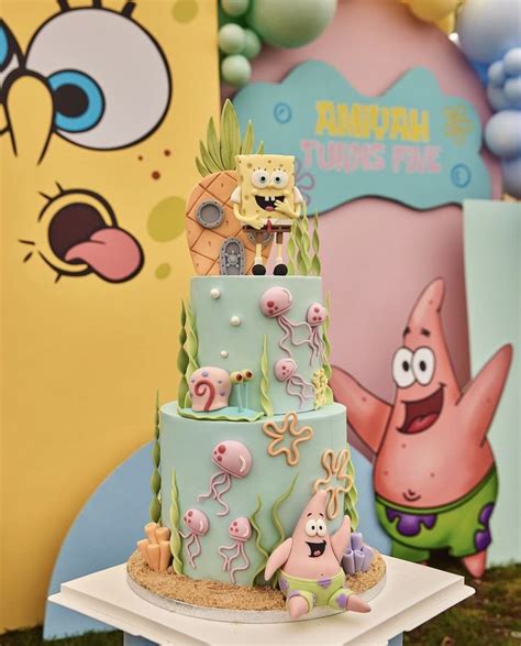 Spongebob Themed Birthday Cake Sitting On Top Of A Table