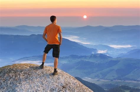 Premium Photo Man On Peak Of Mountain