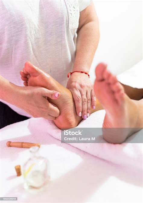 Masseuse Doing Foot Reflexology With The Fingers On Acupressure Point