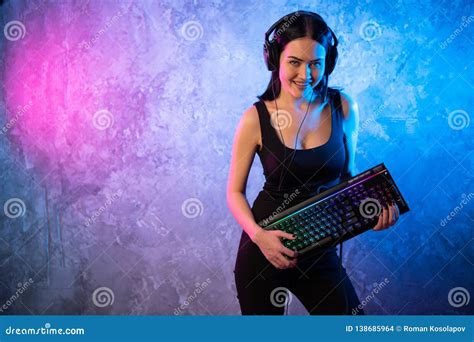 Beautiful Friendly Pro Gamer Streamer Girl Posing With A Keyboard In Her Hands Wearing Glasses