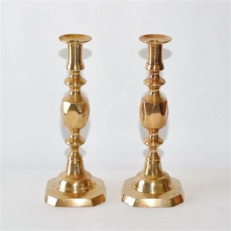 Two Golden Candlesticks Sitting Next To Each Other