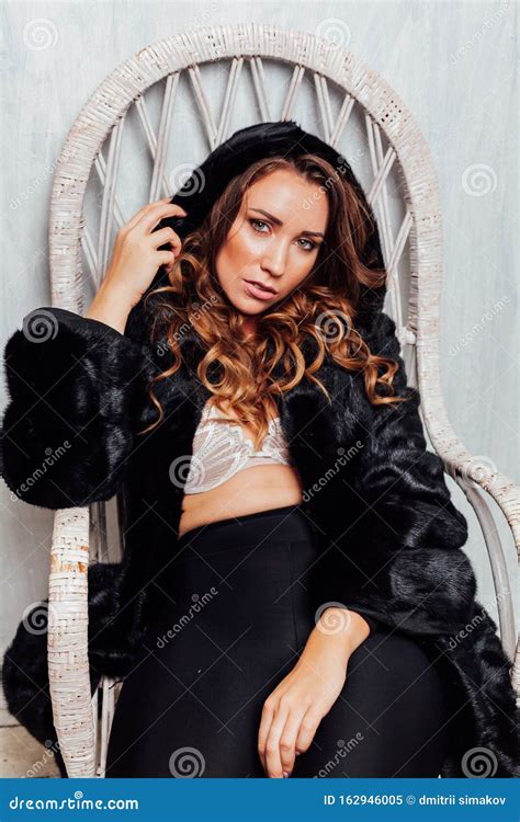 Portrait Of A Beautiful Fashionable Woman With Curls In A Black Fur