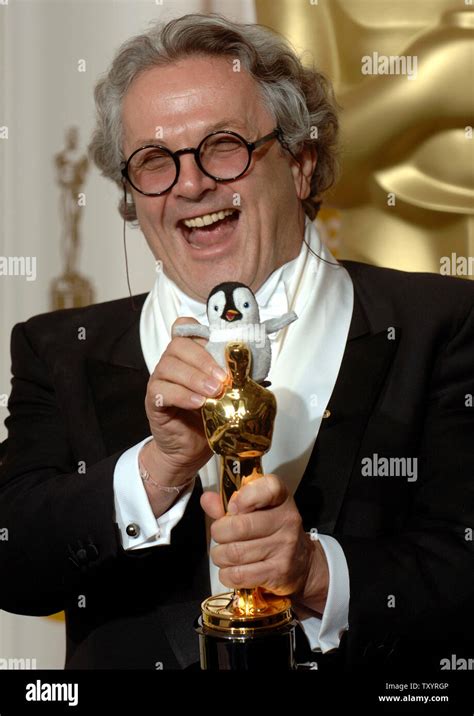 George Miller poses the Oscar he received for the best Animated Feature ...