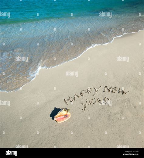 Happy new year written in the beach Stock Photo - Alamy