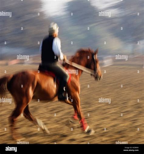 Side profile of a man riding a horse Stock Photo - Alamy