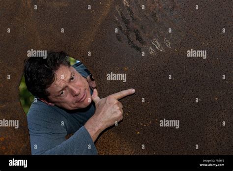 Mature Handsome Successful Businessman Pointing Hand Aside On Copy Space Isolated On Brown
