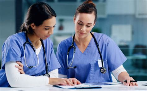 Two Nurses Talking Stock Photos, Pictures & Royalty-Free Images - iStock