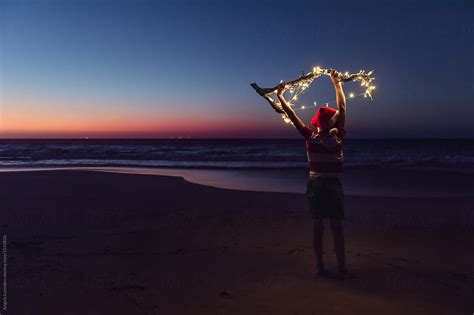 "Playing With Christmas Lights At The Beach After Sunset" by Stocksy ...