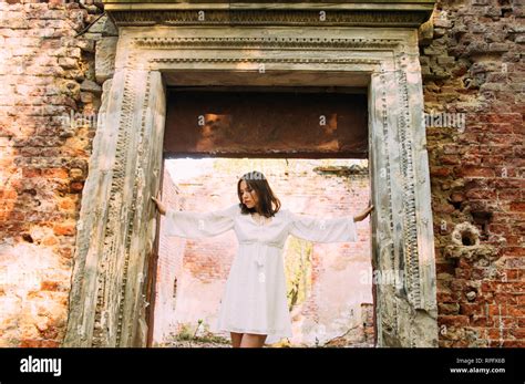 Beautiful Brunette Girl In Arch Of Abandoned Building Stock Photo Alamy