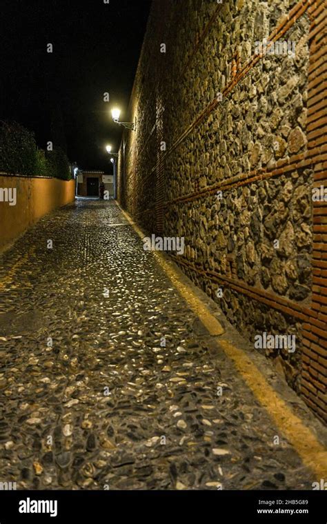 Typical and narrow street of the Albaicin neighborhood Stock Photo - Alamy