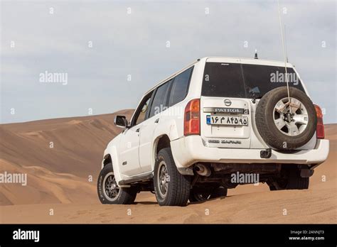 Back View Of White Nissan Patrol Super Safari Climbed On A Sand Dune In