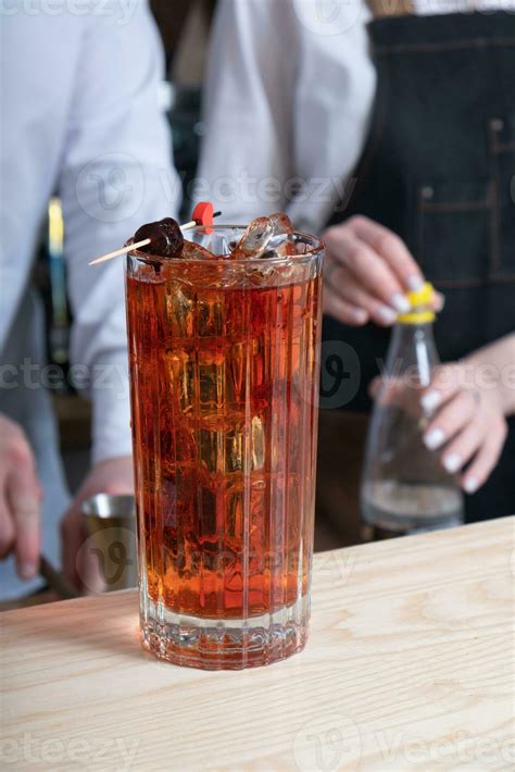 Alcoholic Cocktails With Ice In Glasses On The Bar Table With