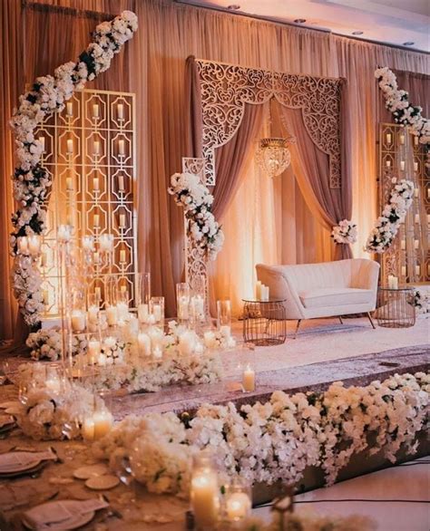 An Elegant Wedding Setup With White Flowers And Candles