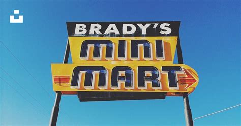 A Sign For A Mini Mart With A Blue Sky In The Background Photo Free