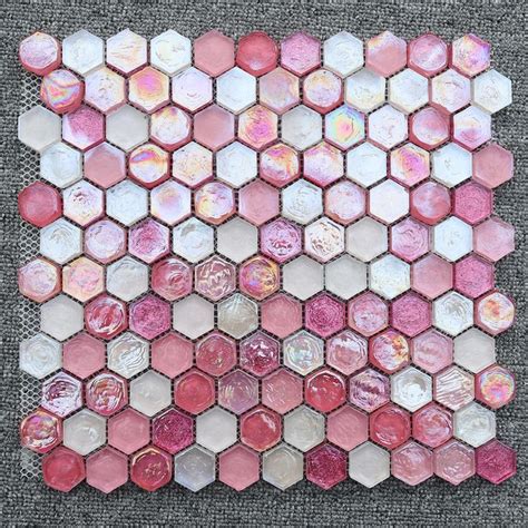 pink and white hexagon tiles are arranged in the shape of an abstract ...