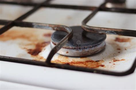 A Dirty Gas Stove With Food Debris Greasy Cooking Stains And Splashes