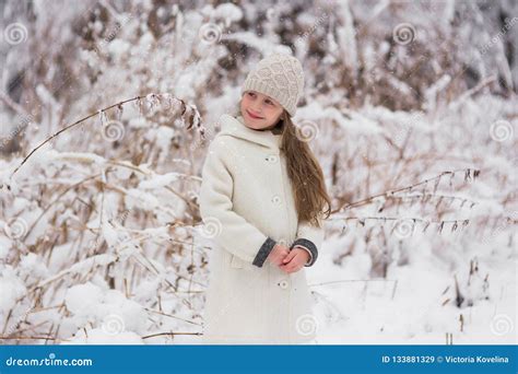 Portrait Of A Cute Smiling Girl On Snowy Day In The Forest Stock Image