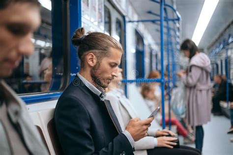 Business Man Using His Smartphone While Sitting In The Train Subway