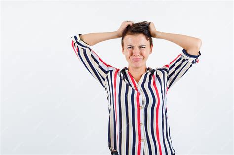 Free Photo Mature Woman Holding Hands On Head In Striped Blouse And