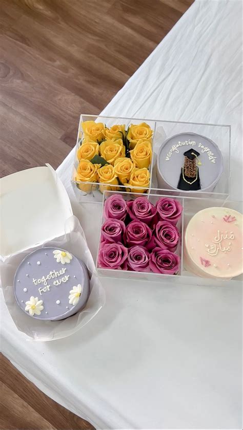 A Table Topped With Cakes And Cupcakes On Top Of A White Table Cloth