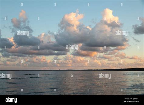 Clouds during sunset on a beach Stock Photo - Alamy