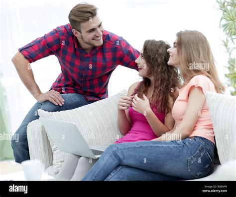 group of students talking,sitting on the couch Stock Photo - Alamy