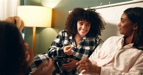 Popcorn Sleepover And Smile With Woman Friends In Bedroom Of Home